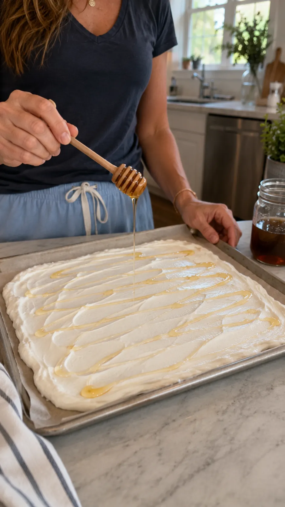 Drizzling honey over Greek yogurt layer